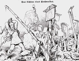 Un homme frappe à la hache sur des barrières et des panneaux de douanes.